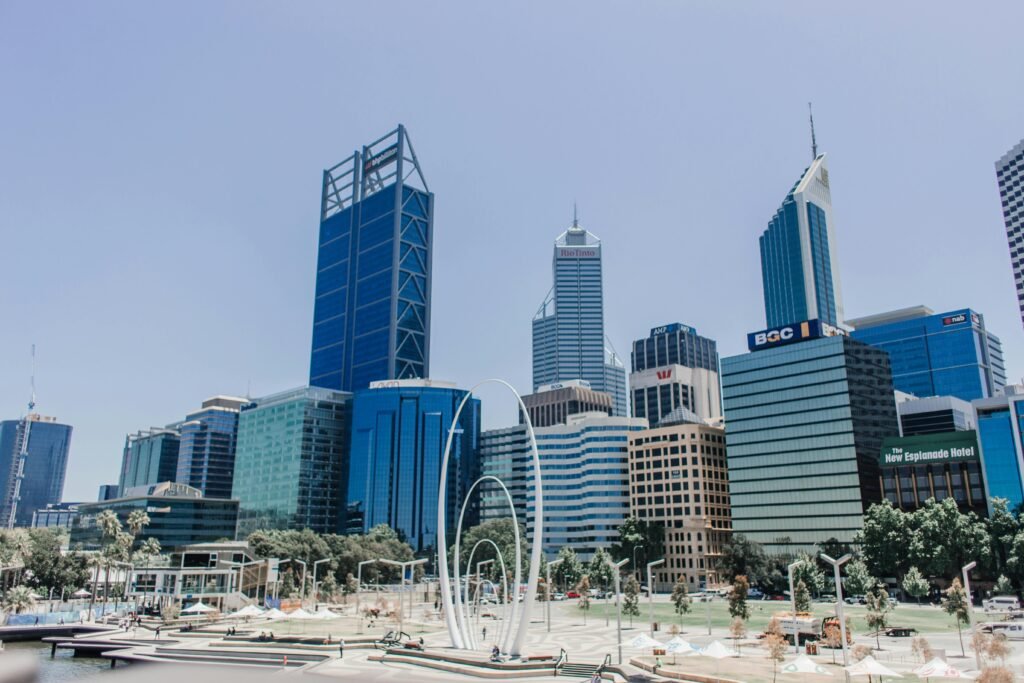 Vibrant skyline of Perth featuring iconic skyscrapers under a clear blue sky.